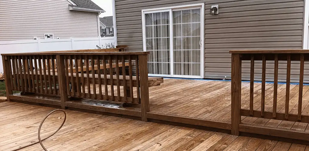 Deck sealing service protecting a backyard wood deck and railings in Ogden, UT