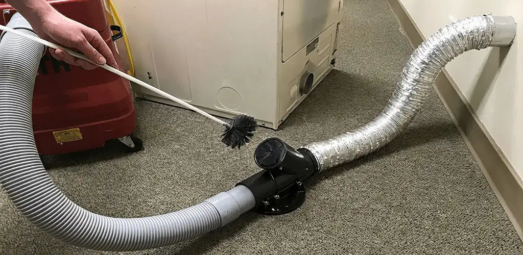 Dryer vent cleaning service removing lint from a dryer duct connection in Ogden, UT