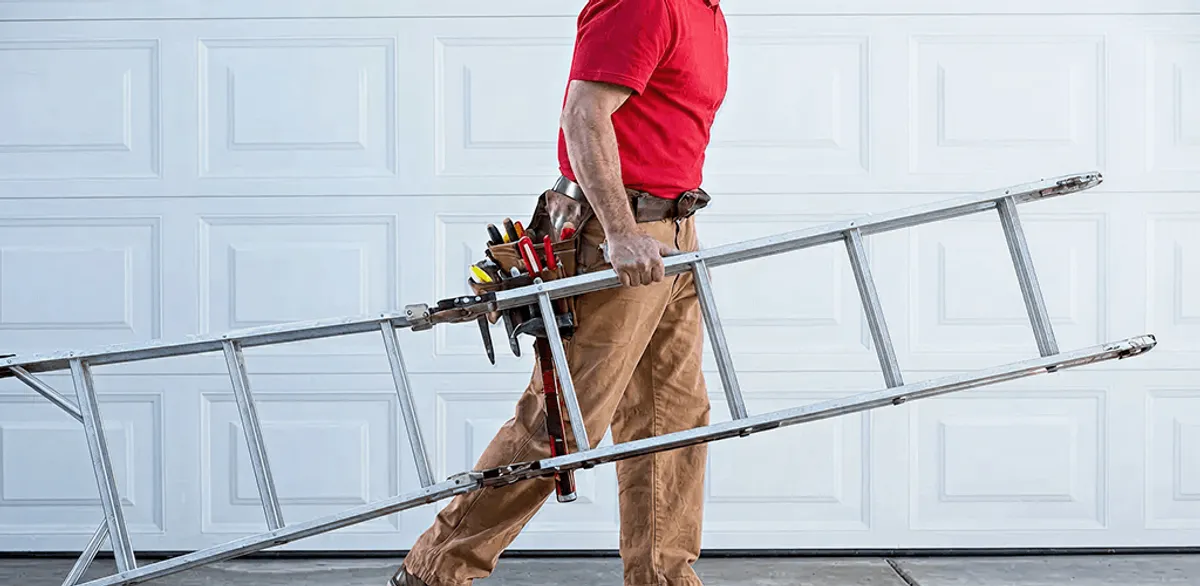 Garage door repair technician arriving with tools and ladder in Ogden, UT