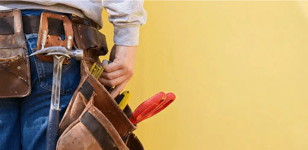 Handyman with tool belt ready for home repairs and maintenance in Ogden, UT