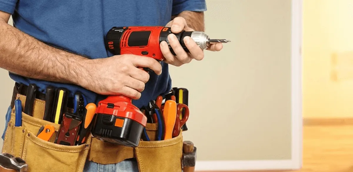 Handyman holding a power drill for home repairs and installations in Ogden, UT