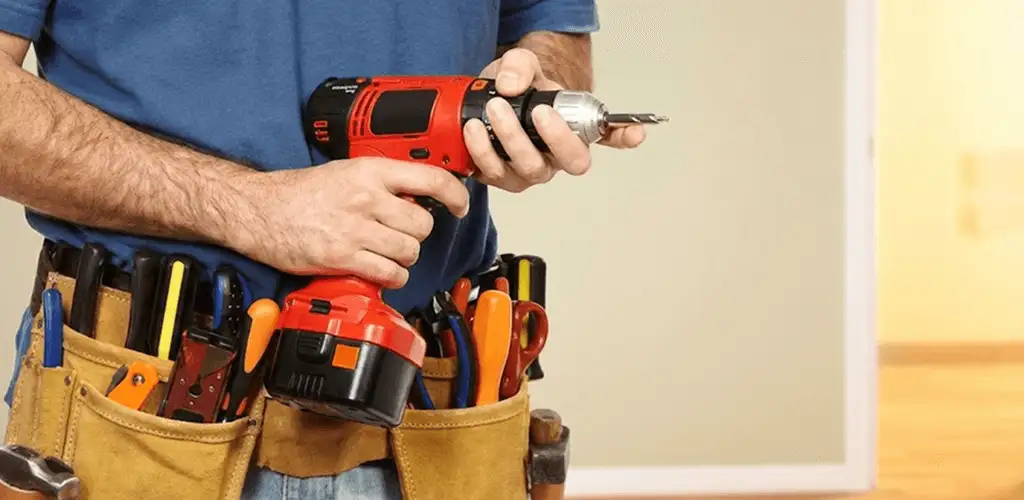 Handyman holding a power drill for home repairs and installations in Ogden, UT