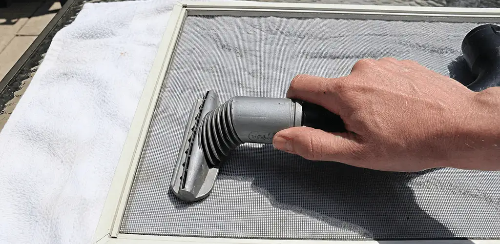 Window screen repair cleaning and fixing a damaged screen mesh in Ogden, UT